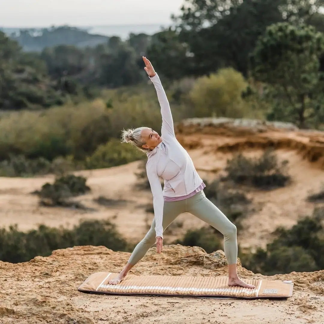 A Women use Amethyst Bio-Mat Professional outside hillside