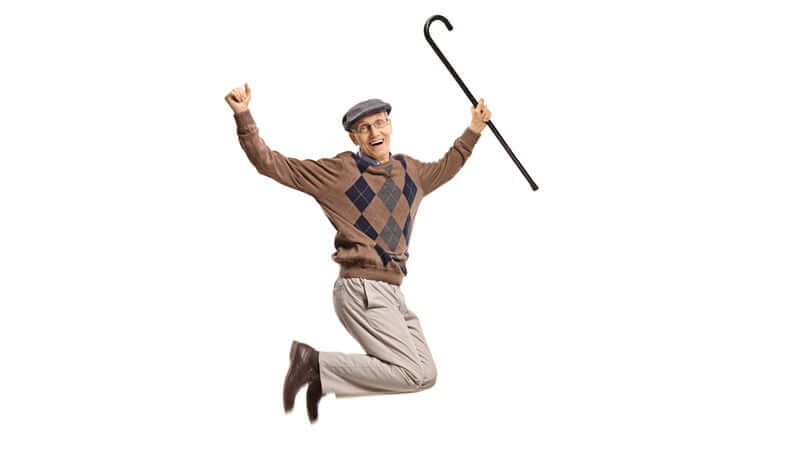 Elderly man joyfully jumping with a cane, representing vitality and youthfulness related to Ecklonia Cava.