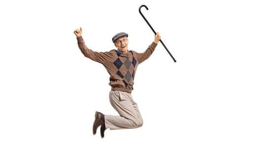 Elderly man joyfully jumping with a cane, representing vitality and youthfulness related to Ecklonia Cava.