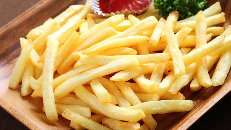 Delicious golden French fries served with ketchup, exploring the question: Are French Fries Vegetables.