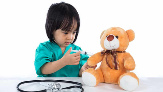 Child administering a shot to a teddy bear, representing themes in 'Do You Need a Flu Shot'.
