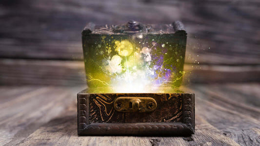 Ancient Secret Science treasure chest with magical light and energy emerging from it on a wooden surface.