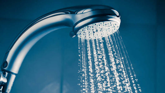 Showerhead releasing water, highlighting the Hazards of Chlorine in Your Shower.