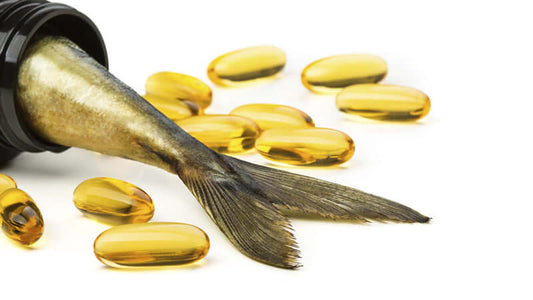 Essential Fats and Women's Health with fish oil capsules and fish tail.