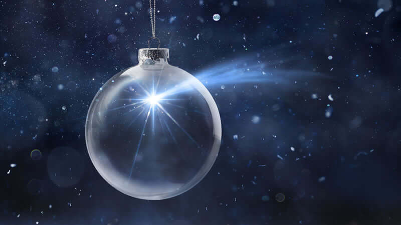 A sparkling clear ornament hanging against a dark background, highlighting the concept of Miraculous Colloids.