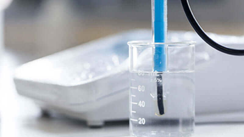 Silica Hydride Effects on Mitochondria experiment with beaker and measurement tool in lab setting.