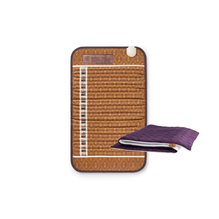 A bamboo cooling mat with a brown patterned cover, shown with a folded purple cooling towel accessory on a plain white background.