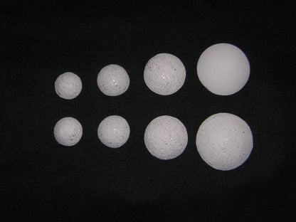 Crystal Pearls Sparkly – a collection of various sizes of sparkly white crystal spheres on a black background.