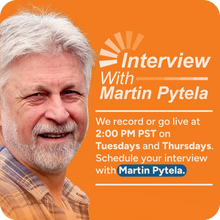 interview with Martin Pytela, featuring a smiling man with white hair and beard on the left, set against a solid orange background with white and blue text on the right.
