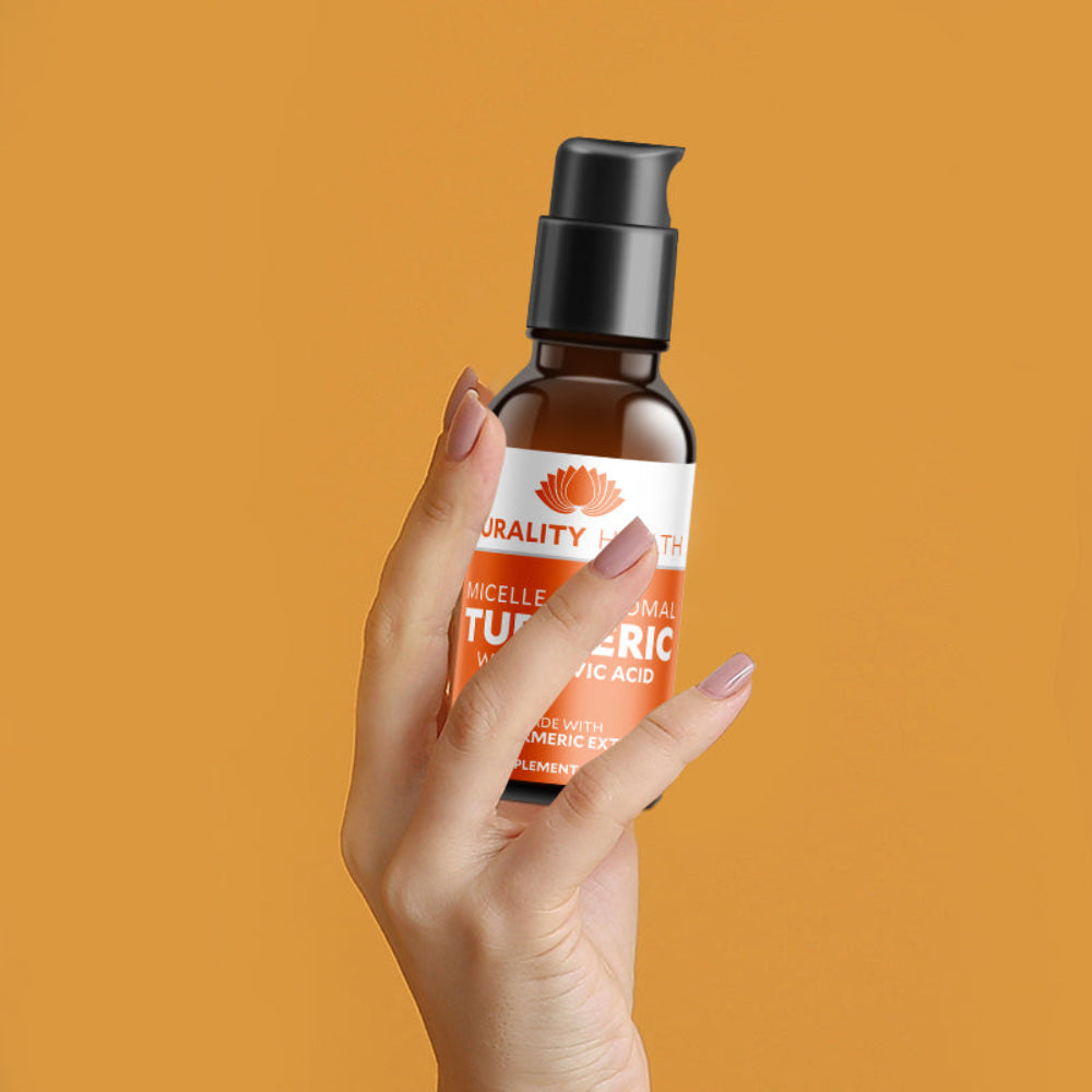 Person holding a bottle of Turmeric - Liposomal Curcumin Blend on an orange background.