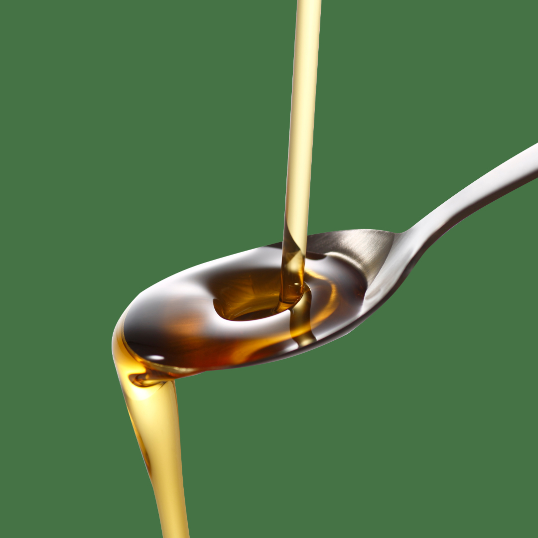 Liposomal Liquid Blend being poured from a spoon, showcasing its smooth and rich texture.
