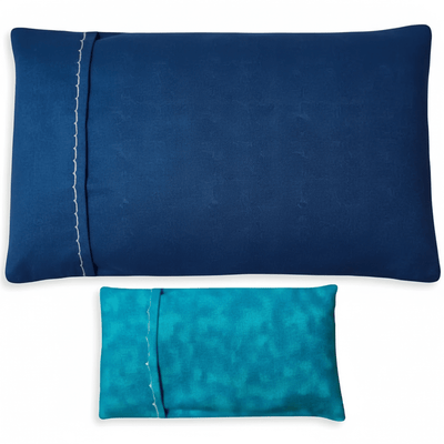 Two blue pillowcases, one lighter, one darker on a white background